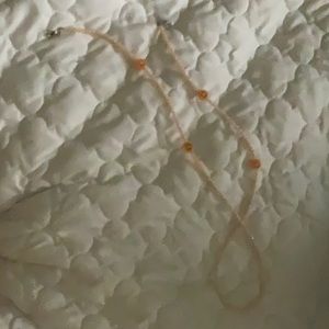 i am selling an bright orange smiley face necklace.